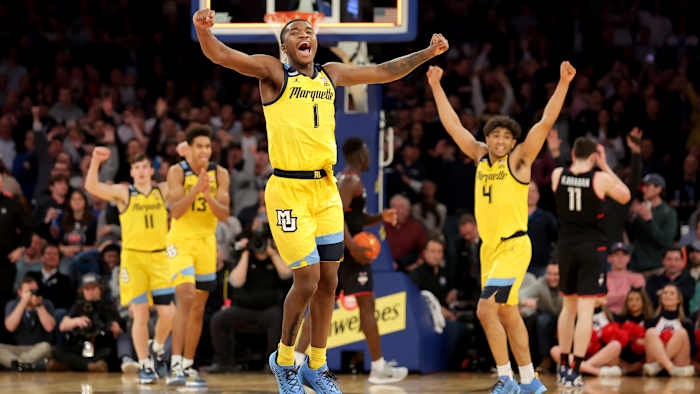 Marquette Golden Eagles guard Kam Jones, guard Tyler Kolek, forward Oso Ighodaro and guard Stevie Mitchell celebrate after defeating the Connecticut Huskies.